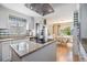 Modern kitchen features granite countertops, stainless steel appliances, and an island with stylish range hood above at 36750 Beth Ave, Zephyrhills, FL 33542