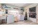 Utility room features a sink, newer washer/dryer, and ample storage shelving at 36750 Beth Ave, Zephyrhills, FL 33542