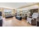 Spacious living room featuring two sofas, an accent chair, ottomans and plenty of natural light at 36750 Beth Ave, Zephyrhills, FL 33542