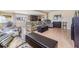 Comfortable living room featuring plush seating, shelving and natural light from a large window at 36750 Beth Ave, Zephyrhills, FL 33542