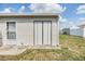 Exterior view of a clean, well-maintained shed with double doors, providing additional storage space on the property at 36750 Beth Ave, Zephyrhills, FL 33542