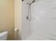 Clean shower stall with white surround, convenient shelving and a modern shower head at 36750 Beth Ave, Zephyrhills, FL 33542