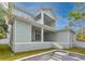 Back exterior view featuring a multi-story covered patio and staircase leading to a well-manicured yard and incomplete pool at 4311 W Sevilla St, Tampa, FL 33629