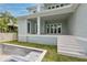 Multi-story covered patio with staircase overlooking the yard featuring an incomplete pool at 4311 W Sevilla St, Tampa, FL 33629