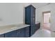 Bathroom featuring custom cabinets, double sinks with stone countertop, and sleek fixtures, combining style and practicality at 4311 W Sevilla St, Tampa, FL 33629