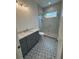 Contemporary bathroom boasting unique floor tiles, a glass shower, and a gray vanity with marble countertop at 4311 W Sevilla St, Tampa, FL 33629