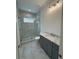 Modern bathroom featuring marble tiles, glass-enclosed shower, and stylish vanity with marble countertop at 4311 W Sevilla St, Tampa, FL 33629