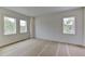 Bright bedroom features natural light from two windows and neutral walls at 4311 W Sevilla St, Tampa, FL 33629