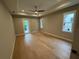 Spacious bedroom features hardwood floors, a ceiling fan, and a private balcony at 4311 W Sevilla St, Tampa, FL 33629