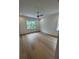Bright bedroom with hardwood floors, a ceiling fan, and large windows overlooking the lush outdoors at 4311 W Sevilla St, Tampa, FL 33629