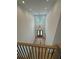 Grand entryway featuring high ceilings, a modern chandelier, and a view of the front door from the staircase at 4311 W Sevilla St, Tampa, FL 33629