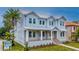 Charming two-story home featuring a metal roof, covered porch, and neatly landscaped front yard at 4311 W Sevilla St, Tampa, FL 33629