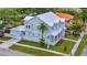 Side angle of the home featuring a metal roof, garage, palm trees, and landscaped yard at 4311 W Sevilla St, Tampa, FL 33629