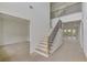 Bright foyer showcasing staircase with iron railings and natural light, offering a welcoming entrance to the home at 4311 W Sevilla St, Tampa, FL 33629
