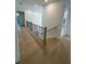 Hallway with hardwood floors, railing and a view of the stairs at 4311 W Sevilla St, Tampa, FL 33629