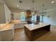 Gourmet kitchen featuring white cabinets, center island, and modern lighting fixtures at 4311 W Sevilla St, Tampa, FL 33629