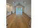 Large living room with high vaulted ceilings, light wood floors, and access to a porch through French doors at 4311 W Sevilla St, Tampa, FL 33629
