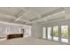 Open-concept living area with a coffered ceiling, island, and doors leading to a patio at 4311 W Sevilla St, Tampa, FL 33629