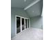 Covered patio featuring tile flooring and direct access to the home through elegant glass doors at 4311 W Sevilla St, Tampa, FL 33629
