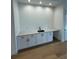 Stylish wet bar area featuring white cabinets, a countertop, sink, and modern fixtures at 4311 W Sevilla St, Tampa, FL 33629