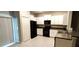 The kitchen features white cabinetry, black appliances, and countertop space at 4505 Globe Thistle Dr, Tampa, FL 33619
