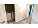 This carpeted laundry room features a washer and dryer set and access to the hall at 4505 Globe Thistle Dr, Tampa, FL 33619