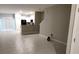 Open-concept living room boasts tile floors, flowing into the kitchen area with modern appliances at 4505 Globe Thistle Dr, Tampa, FL 33619