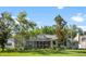 Spacious backyard featuring a screened-in patio, lush lawn, mature trees, and plenty of room for outdoor living at 4508 Netherwood Dr, Tampa, FL 33624