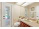 Bright bathroom with vanity, neutral fixtures, door to pool deck, and large mirror for getting ready at 4508 Netherwood Dr, Tampa, FL 33624