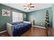 Comfortable bedroom featuring a unique headboard design, ceiling fan, and plenty of natural light at 4508 Netherwood Dr, Tampa, FL 33624