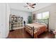 Cozy bedroom with hardwood floors, a ceiling fan, and natural light at 4508 Netherwood Dr, Tampa, FL 33624