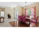Elegant dining room features stylish lighting and floral curtains, wood floors, and access to an office at 4508 Netherwood Dr, Tampa, FL 33624