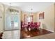 Formal dining room with modern chandelier, hardwood floors, and decorative doorway to foyer at 4508 Netherwood Dr, Tampa, FL 33624