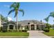 Charming single-story home with lush landscaping, paved driveway, and inviting entryway with stately columns at 4508 Netherwood Dr, Tampa, FL 33624