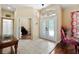 The foyer is bright and open with a view of a den and decorative doors to the dining area at 4508 Netherwood Dr, Tampa, FL 33624