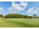 Scenic view of the golf course with lush green fairway and water hazard on a sunny day at 4508 Netherwood Dr, Tampa, FL 33624