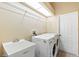 Functional laundry room with washer, dryer, utility sink, and storage shelving at 4508 Netherwood Dr, Tampa, FL 33624