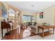Comfortable and airy living room showcasing hardwood floors, neutral paint, and large windows at 4508 Netherwood Dr, Tampa, FL 33624