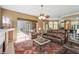 Inviting living room with a cozy fireplace, ceiling fan, and sliding glass doors to the outdoor pool area at 4508 Netherwood Dr, Tampa, FL 33624
