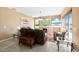 Cozy living room with fireplace, large windows, comfortable seating, and access to outdoor pool area at 4508 Netherwood Dr, Tampa, FL 33624