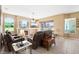 Inviting living room featuring a fireplace, large windows, and comfortable seating arrangement at 4508 Netherwood Dr, Tampa, FL 33624
