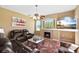 Cozy living room with a fireplace, comfortable seating, and a large window view at 4508 Netherwood Dr, Tampa, FL 33624