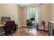 Well-lit office with modern decor, hardwood floors, and a large bright window at 4508 Netherwood Dr, Tampa, FL 33624