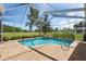 Enclosed pool with a serene view of the surrounding landscape at 4508 Netherwood Dr, Tampa, FL 33624