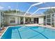 Stunning screened pool with walk-in steps, surrounded by a spacious patio perfect for enjoying the outdoors at 4508 Netherwood Dr, Tampa, FL 33624