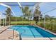 Enclosed pool area with stunning golf course views, beautiful blue water and stone waterfall feature at 4508 Netherwood Dr, Tampa, FL 33624