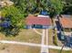An aerial view showcases this charming single-story home with a spacious yard and driveway at 4706 E Sligh Ave, Tampa, FL 33610