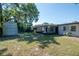 Expansive backyard showcasing the storage shed, patio, and lush landscaping at 4706 E Sligh Ave, Tampa, FL 33610