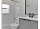 Bathroom with tiled shower/tub and a gray vanity with an eye-catching black faucet and mirror at 4706 E Sligh Ave, Tampa, FL 33610