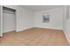 Neutral bedroom featuring tile floors and a window with natural lighting at 4706 E Sligh Ave, Tampa, FL 33610